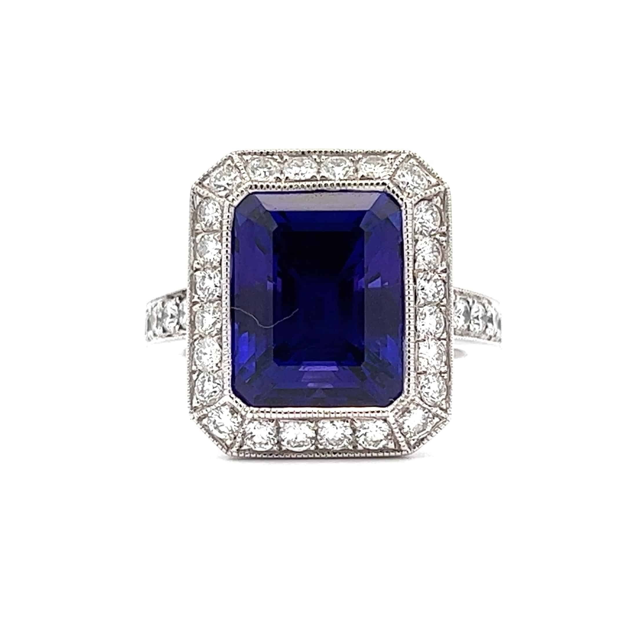 Preowned Platinum 8.98ct AAAA Emerald Cut Tanzanite and Diamond Ring – 1.19ct Total Diamond Weight